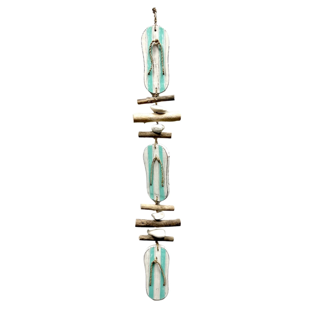 aqua flip flop strand with driftwood and stone accents hanging from a seagrass rope-