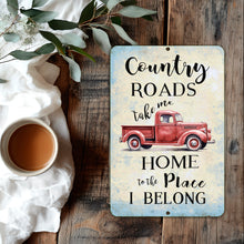 Load image into Gallery viewer, Country Roads Take Me Home Metal Sign by Dyenamic Art featuring a vintage red pickup truck with rustic typography on a distressed background.
