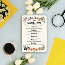 Load image into Gallery viewer, Dyenamic Art Heart of a Friend Metal Sign on a pastel-themed desk with tulips, coffee, and stationery, adding warmth to the space
