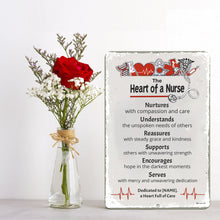 Load image into Gallery viewer, Dyenamic Art Heart of a Nurse Metal Sign displayed with a floral arrangement, showcasing its elegant and heartfelt design.
