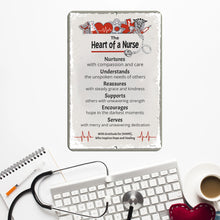 Load image into Gallery viewer, Heart of a Nurse Metal Sign on a desk with a keyboard and stethoscope, symbolizing dedication in the medical field.
