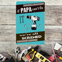 Load image into Gallery viewer, Dyenamic Art Papa Fix It Metal Sign on a workbench surrounded by tools, ideal for DIY lovers and mechanics.
