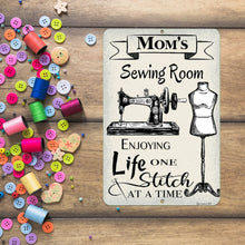 Load image into Gallery viewer, Dyenamic Art Personalized Sewing Room Metal Sign surrounded by colorful buttons and thread, capturing the spirit of crafting
