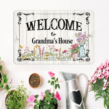 Load image into Gallery viewer, Dyenamic Art Welcome to Grandma’s House Custom Metal Sign displayed with flowers, customizable for any name.
