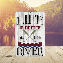 Load image into Gallery viewer, Rustic Life Is Better at the River Metal Sign displayed near a peaceful river setting, adding charm to cabins, docks, and riverfront retreats.
