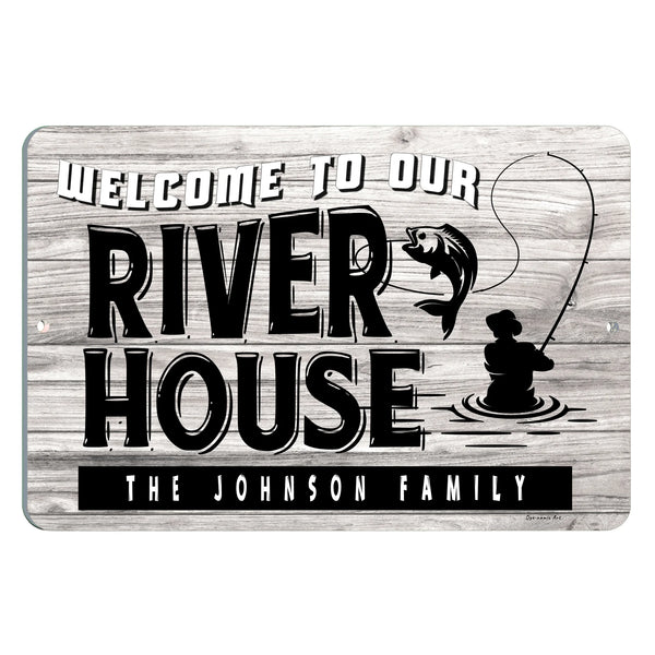 Dyenamic Art Personalized River House Metal Sign – Rustic fishing cabin sign with a fisherman silhouette and leaping fish on a wood-style background.