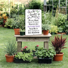 Load image into Gallery viewer, Garden Rules Nurture Love Metal Sign set up in an outdoor gardening space with planters and vibrant plants.
