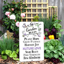 Load image into Gallery viewer, Dyenamic Art Garden Rules Nurture Love Metal Sign in a blooming flower garden with pink roses and fresh herbs
