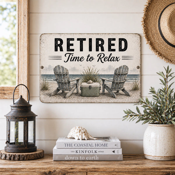 Decorative sign with 'Retired Time to Relax' text on a wall with books and decor items below.