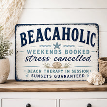 Load image into Gallery viewer, Beachaholic metal sign displayed in a coastal beach house with seashell decor and relaxed seaside styling
