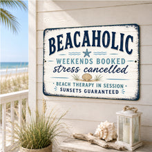 Load image into Gallery viewer, Beachaholic metal sign displayed on a coastal porch overlooking the beach with seashell decor and ocean views
