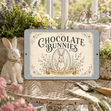 Load image into Gallery viewer, Chocolate Bunnies cottagecore sign displayed in a sunroom garden setting beside a ceramic rabbit and spring flowers
