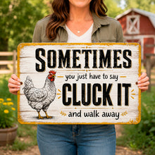 Load image into Gallery viewer, Woman holding the Cluck It funny chicken metal sign, a humorous farmhouse gift for chicken lovers and backyard flock owners
