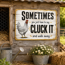 Load image into Gallery viewer, Funny Cluck It chicken metal sign displayed in a cozy farmhouse kitchen with rustic wood accents and country decor
