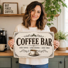 Load image into Gallery viewer, Woman holding the Coffee Bar metal sign in a bright kitchen, showing the size and style of the vintage coffee station decor
