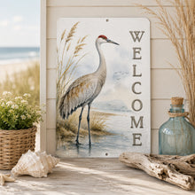 Load image into Gallery viewer, Decorative sign with a crane illustration and 'Welcome' text on a wooden surface with beach-themed decor.
