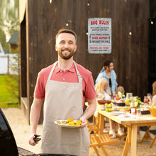 Load image into Gallery viewer, BBQ Rules Metal Sign – Displayed at a Backyard Cookout with a Smiling Grill Master, Creating a Fun and Inviting Atmosphere for Family Gatherings, Outdoor Feasts, and Summer Parties.
