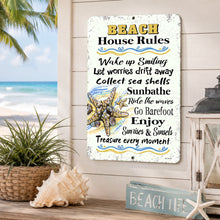 Load image into Gallery viewer, Beach House Rules metal sign hanging on a coastal porch wall with beach decor, seashell, lantern, palm trees, and ocean view in the background.
