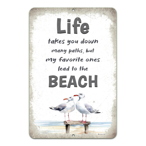 Dyenamic Art 'Life Takes You to the Beach' metal sign featuring two seagulls on a weathered wood dock with a distressed beige background. A charming coastal wall decor piece.
