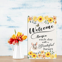 Load image into Gallery viewer, Bunny Rabbit Welcome Metal Sign displayed on a rustic table with fresh tulips for a cozy, inviting decor touch.
