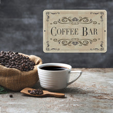 Load image into Gallery viewer, Elegant Coffee Bar Metal Sign displayed with a steaming cup of black coffee and a sack of roasted coffee beans, creating a cozy and inviting coffee station ambiance.
