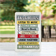 Load image into Gallery viewer, A detailed close-up of the Dyenamic Art Deck Rules metal sign, showcasing its vibrant multicolored wooden-style background and bold, playful text.
