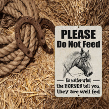 Load image into Gallery viewer, Rustic Do Not Feed Horses sign placed on a bed of hay with vintage horseshoes, adding a Western touch to barns and horse stables.
