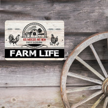 Load image into Gallery viewer, Farm Life Inspirational Metal Sign displayed against a rustic wooden background with a vintage wagon wheel, adding charm to farmhouse or country home decor.
