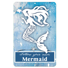 Load image into Gallery viewer, Dyenamic Art 'Follow Your Inner Mermaid' metal sign featuring an elegant white mermaid silhouette on a distressed blue wood-style background. A whimsical coastal wall decor piece.
