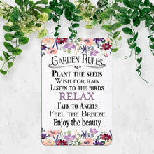 Load image into Gallery viewer, Dyenamic Art Garden Rules Metal Sign styled against greenery, perfect for garden lovers and nature-inspired decor.
