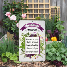 Load image into Gallery viewer, Herb Garden Wisdom Metal Sign styled among fresh herbs and flowers, ideal for kitchen or outdoor decor

