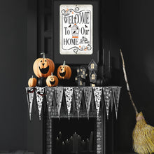 Load image into Gallery viewer, Welcome to Our Home Halloween sign hanging above a gothic fireplace display with jack-o&#39;-lanterns and ghostly banners.

