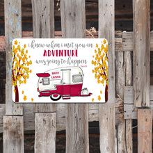 Load image into Gallery viewer, Happy Campers Metal Sign styled outdoors on a weathered wooden fence, creating a cozy travel and adventure-themed setting.
