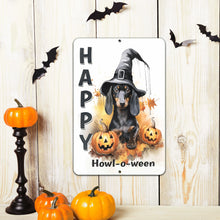 Load image into Gallery viewer, Halloween-themed wall decor featuring the Happy Howl-o-ween Metal Sign, surrounded by festive pumpkins and hanging bats on a light wooden background. A fun and whimsical touch for Halloween decorating.
