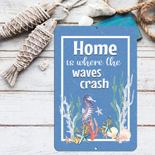 Load image into Gallery viewer, Indoor decor arrangement with the Dyenamic Art Home Is Where the Waves Crash Metal Sign, adding an ocean-inspired touch to a cozy living space.
