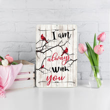 Load image into Gallery viewer, I Am Always With You Cardinal Metal Sign – Inspirational memorial wall art with red cardinals on branches, displayed on a white brick background with pink tulips.
