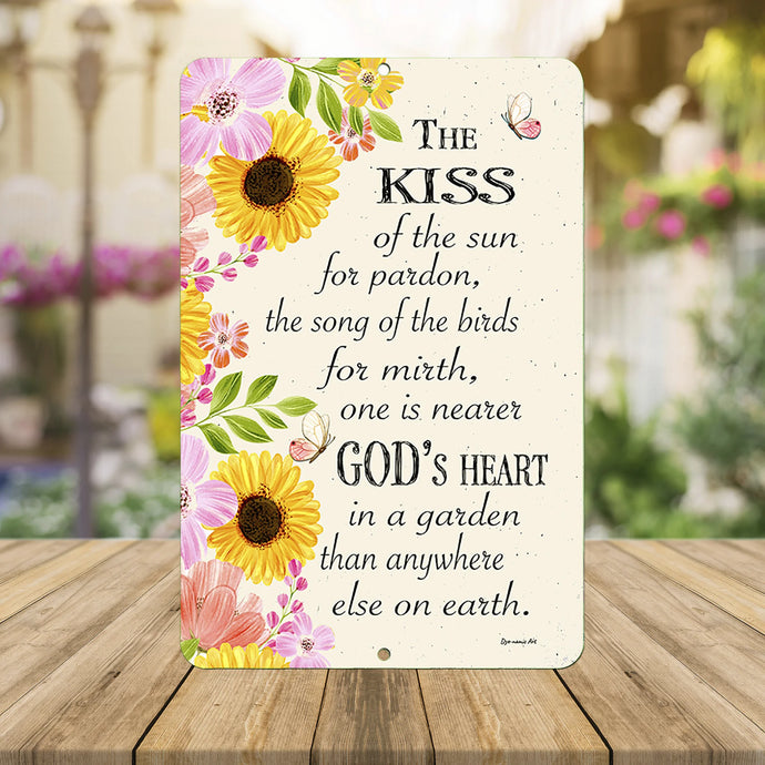 A close-up shot of the Kiss of the Sun garden metal sign, highlighting intricate floral details, butterfly accents, and elegant typography on a soft cream background.