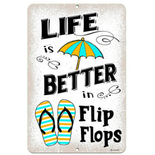 Load image into Gallery viewer, Dyenamic Art &#39;Life is Better in Flip Flops&#39; metal sign featuring bright striped flip-flops and a colorful beach umbrella on a distressed white background. A fun summer-themed decor piece.
