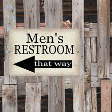 Load image into Gallery viewer, Men’s Restroom That Way Metal Sign mounted on a rustic wooden fence, directing guests and customers with a stylish vintage design.
