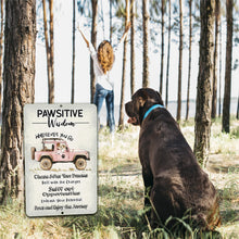 Load image into Gallery viewer, Pawsitive Wisdom Metal Sign – Inspirational pet-themed wall décor displayed in nature, capturing an adventurous spirit with a dog.
