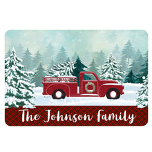 Load image into Gallery viewer, Personalized Red Truck Christmas Metal Sign – A festive winter scene with a vintage red truck, snowy pine trees, and a customizable family name banner. 
