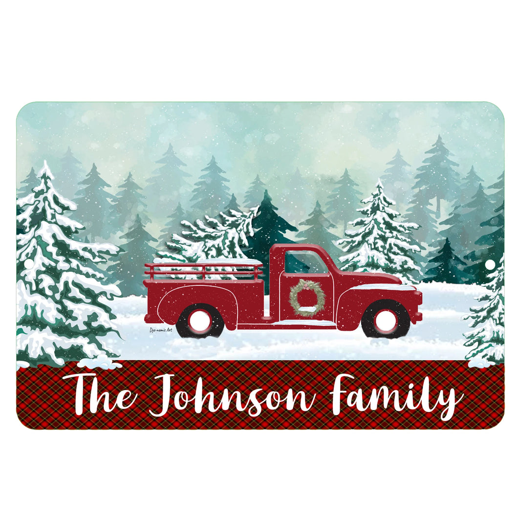 Personalized Red Truck Christmas Metal Sign – A festive winter scene with a vintage red truck, snowy pine trees, and a customizable family name banner. 