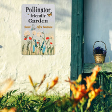 Load image into Gallery viewer, Pollinator Garden Metal Sign displayed on an outdoor wall with natural surroundings, perfect for gardeners and wildlife lovers.
