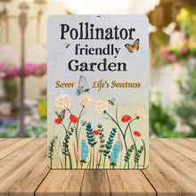 Load image into Gallery viewer, Pollinator Garden Metal Sign set on a wooden surface with a cozy outdoor ambiance, enhancing any yard or greenhouse.
