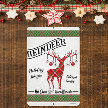 Load image into Gallery viewer, Vintage Christmas reindeer sign hanging on a wooden wall surrounded by pine cones, garland, and festive decorations, perfect for holiday ambiance.
