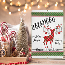 Load image into Gallery viewer, Rustic Reindeer sign placed next to a holiday display of candy canes, cinnamon sticks, and hot cocoa, adding a cozy seasonal touch.
