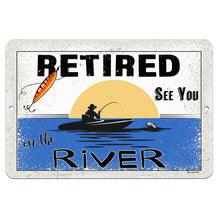 Load image into Gallery viewer, Dyenamic Art - Retired on the River Metal Sign – A Fishing-Inspired Retirement Sign Featuring a Vintage-Style Illustration of a Fisherman Casting a Line at Sunset. Ideal for Cabin, Lodge, or River House Decor.
