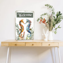 Load image into Gallery viewer, Charming tabletop display of the Seahorse Welcome Sign, styled with natural wood textures, ceramic vases, and soft lighting, perfect for a welcoming home environment.
