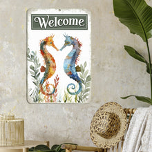 Load image into Gallery viewer, Dyenamic Art Seahorse Welcome Metal Sign hanging in a rustic-inspired room, blending beautifully with neutral tones, woven textures, and tropical-inspired decor elements.
