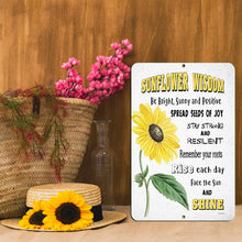 Load image into Gallery viewer, Sunflower Wisdom Metal Sign displayed with a straw hat and floral decor, perfect for farmhouse and nature-inspired spaces.
